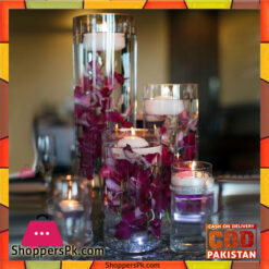 Purple Orchid and Floating Candle Centerpieces at the reception consisted of cylinder vases of various heights.