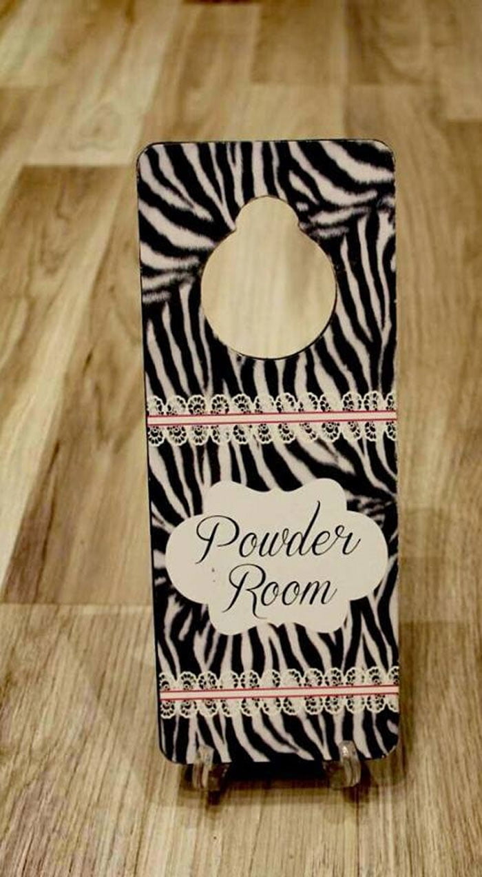 Powder Room Sign Hanging On Door Handle
