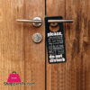 PLEASE DO NOT DISTURB Sign Hanging on Door Handle